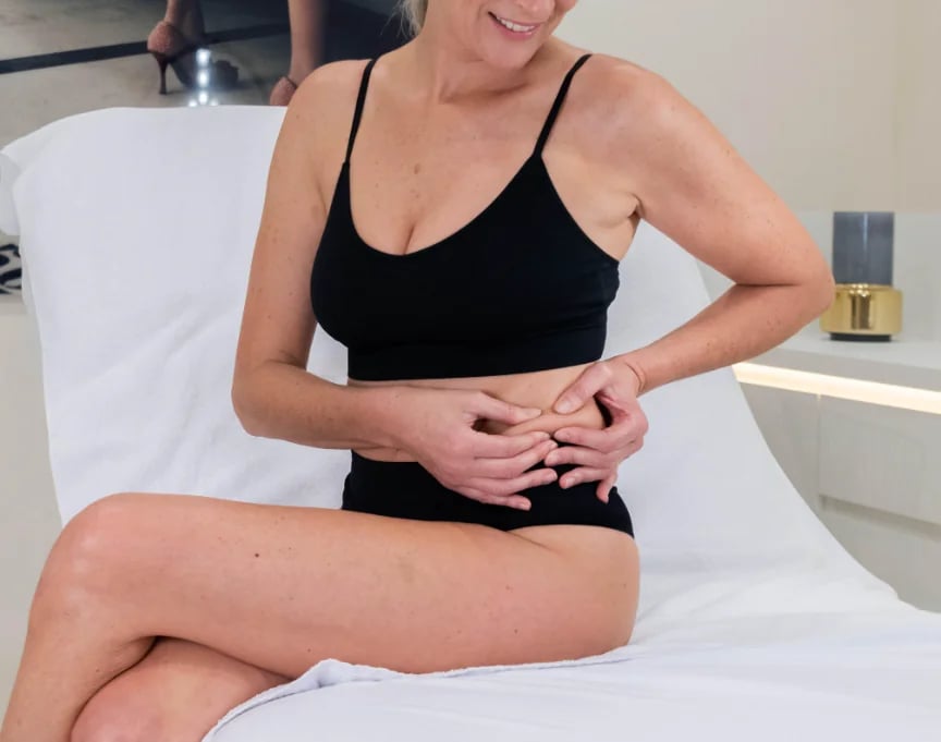 Abdominal assessment during a body contouring consultation in Palm Beach Gardens