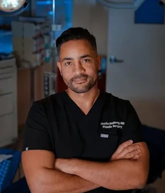Dr. Justin Bellamy in surgical scrubs in his accredited operating room