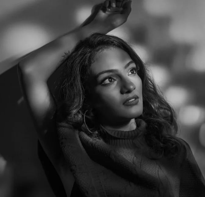 Black and white portrait of a woman considering body contouring options